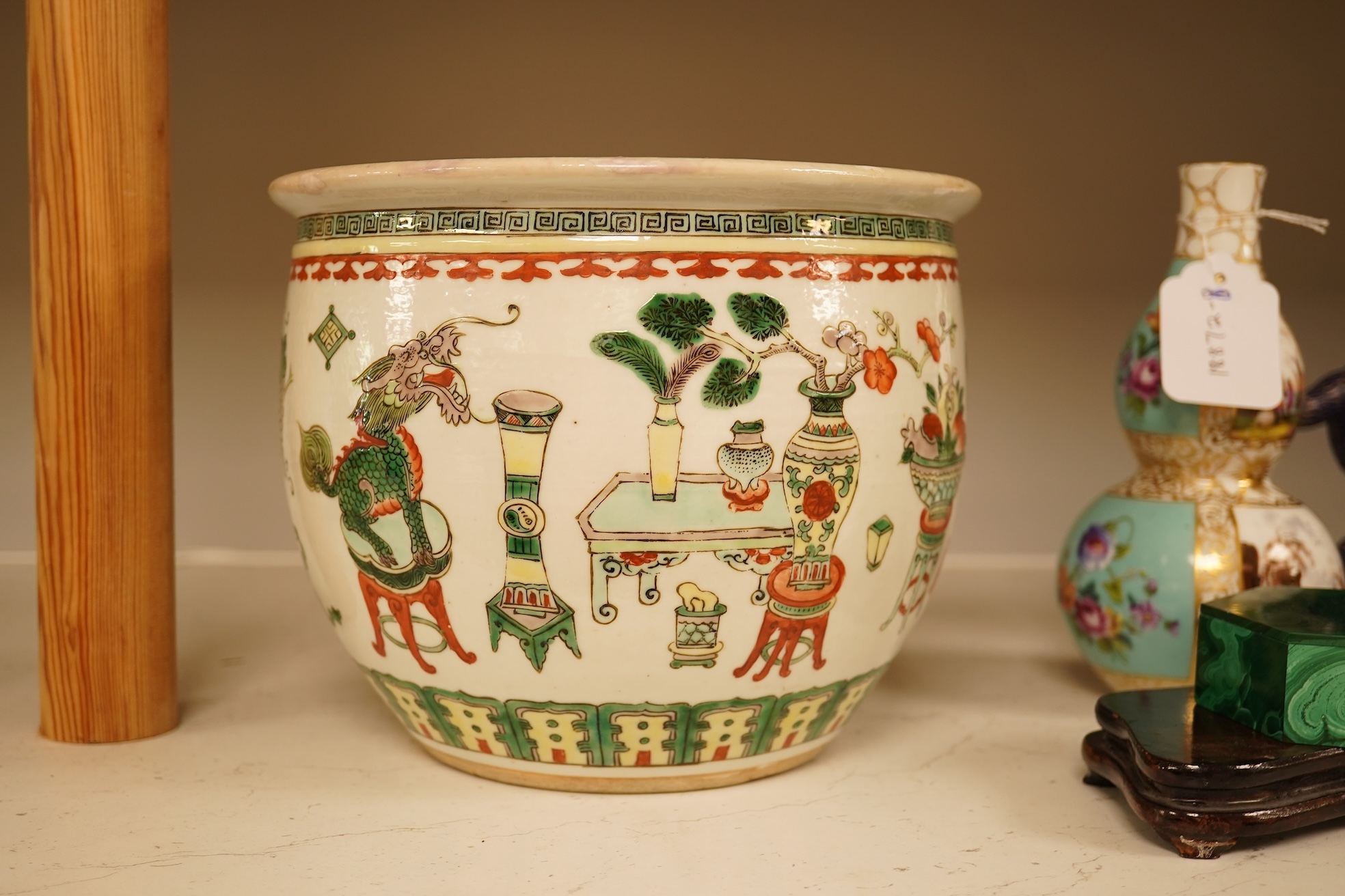 A Chinese Hundred Antiques famille verte small jardiniere, 19th century, 17cm high, 21cm diameter.